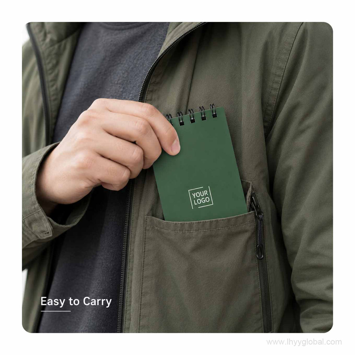 Forest green custom logo pocket spiral notebook carried in a jacket chest pocket for portable field notes.