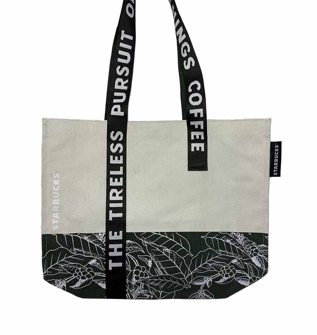 Premium custom-branded canvas tote bag with botanical leaf prints and designer straps, an ideal corporate gift for scientific professionals.