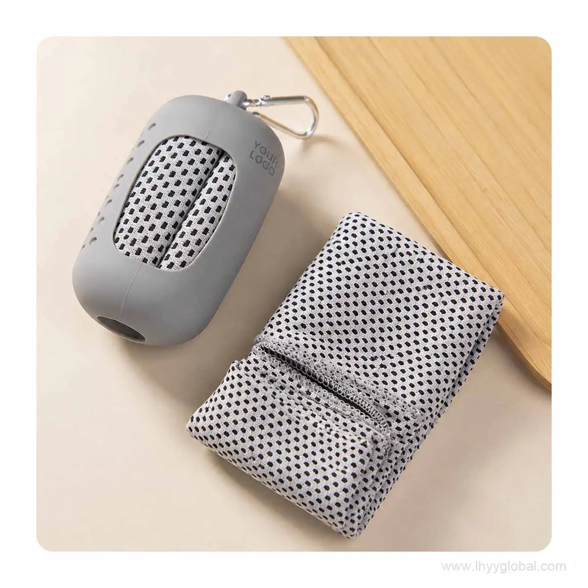 Folded gray quick-dry cooling towel beside a silicone capsule carry case