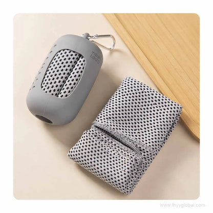 Folded gray quick-dry cooling towel beside a silicone capsule carry case