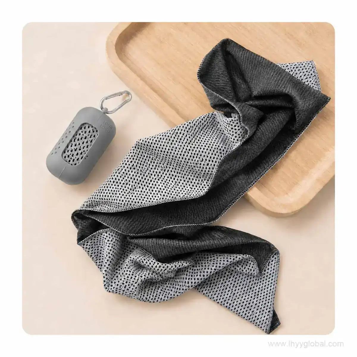 Unfolded cooling towel beside a light gray silicone carry case