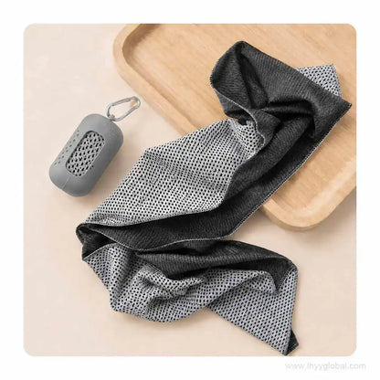 Unfolded cooling towel beside a light gray silicone carry case