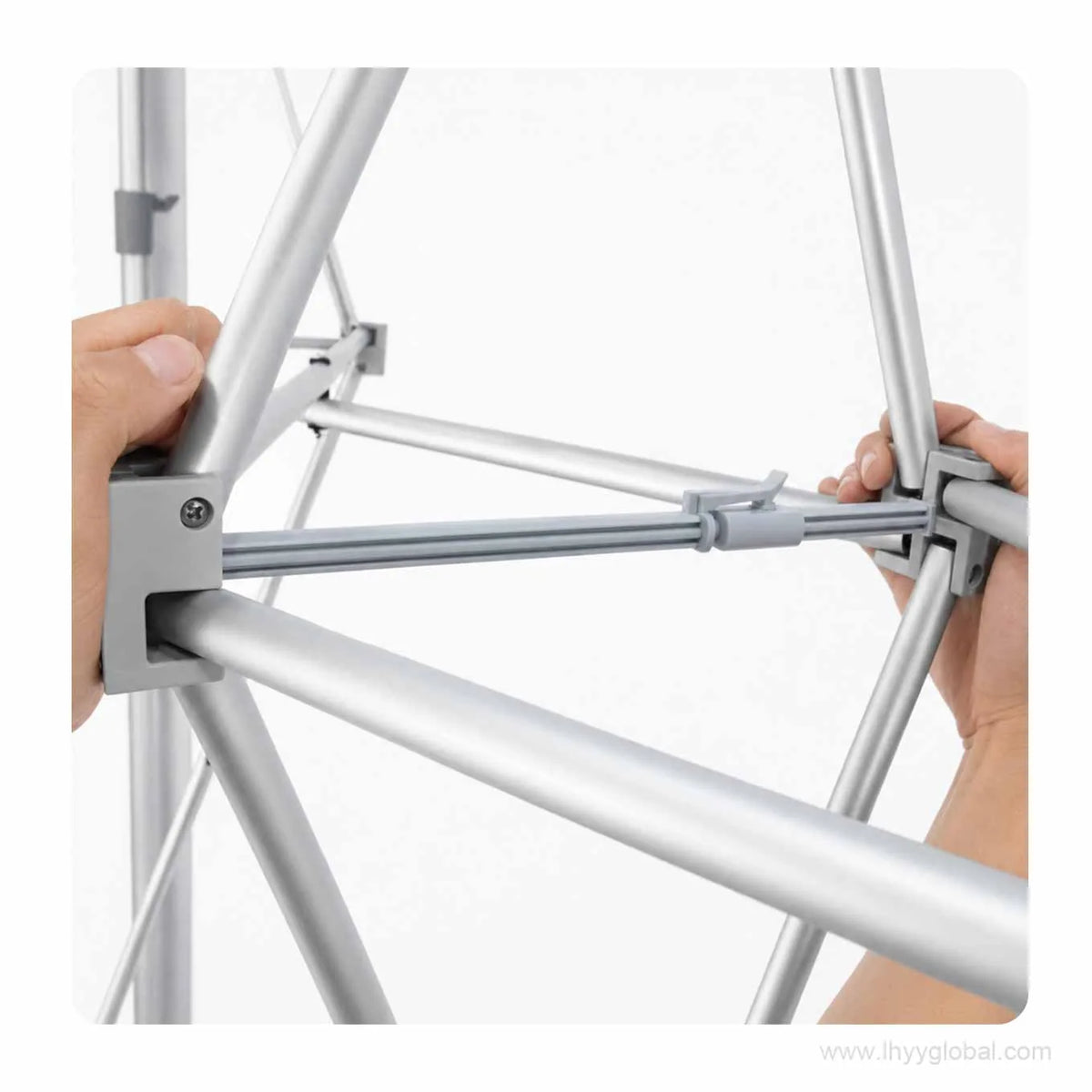 Hands connecting the support bar during tool-free assembly of a pop-up trade show display frame