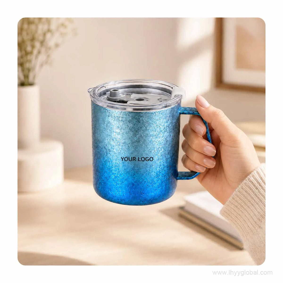 Hand holding a 430 mL gradient blue custom titanium mug with clear lid