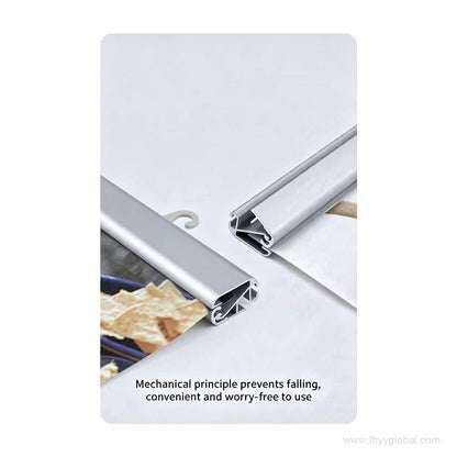 Hand inserting poster material into the aluminum poster hanger rail