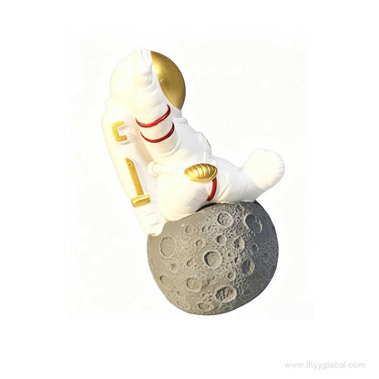 Side view of astronaut Bluetooth speaker sitting on a realistic moon base design