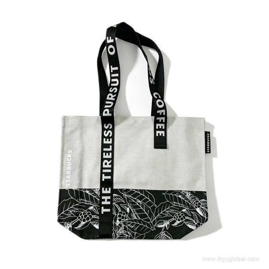 Reference image of a custom corporate tote bag with white canvas and black splicing, woven strap printing, and side label, similar to previous Starbucks corporate branding projects.