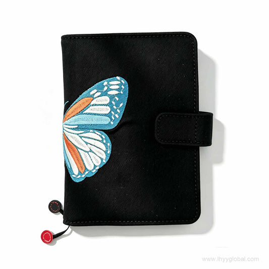 Close-up of magnetic closure and high-quality embroidery on a custom corporate branded notebook cover.