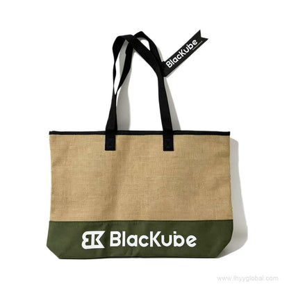Past project reference of a custom organic jute tote bag with white embroidered logo, olive green bottom, and custom woven brand tag for BlackKube corporate gifting events.