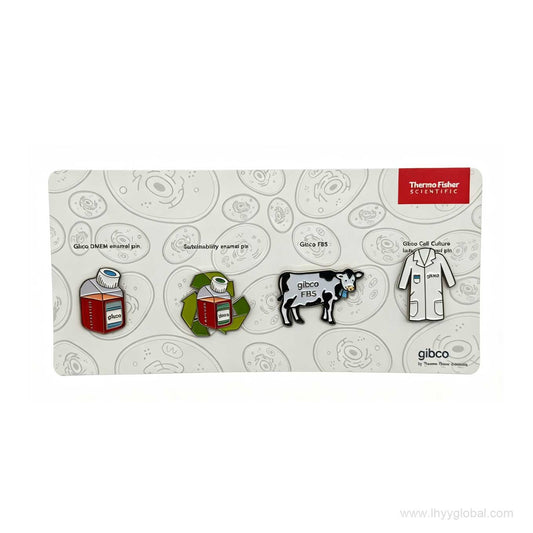 Four Gibco-themed hard enamel lab pins featuring a DMEM bottle, sustainability symbol, FBS cow and cell culture lab coat on a printed backing card