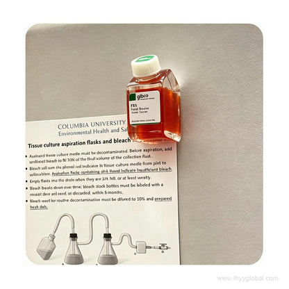 Gibco FBS bottle fridge magnet attached to a safety protocol document, highlighting its magnetic strength.