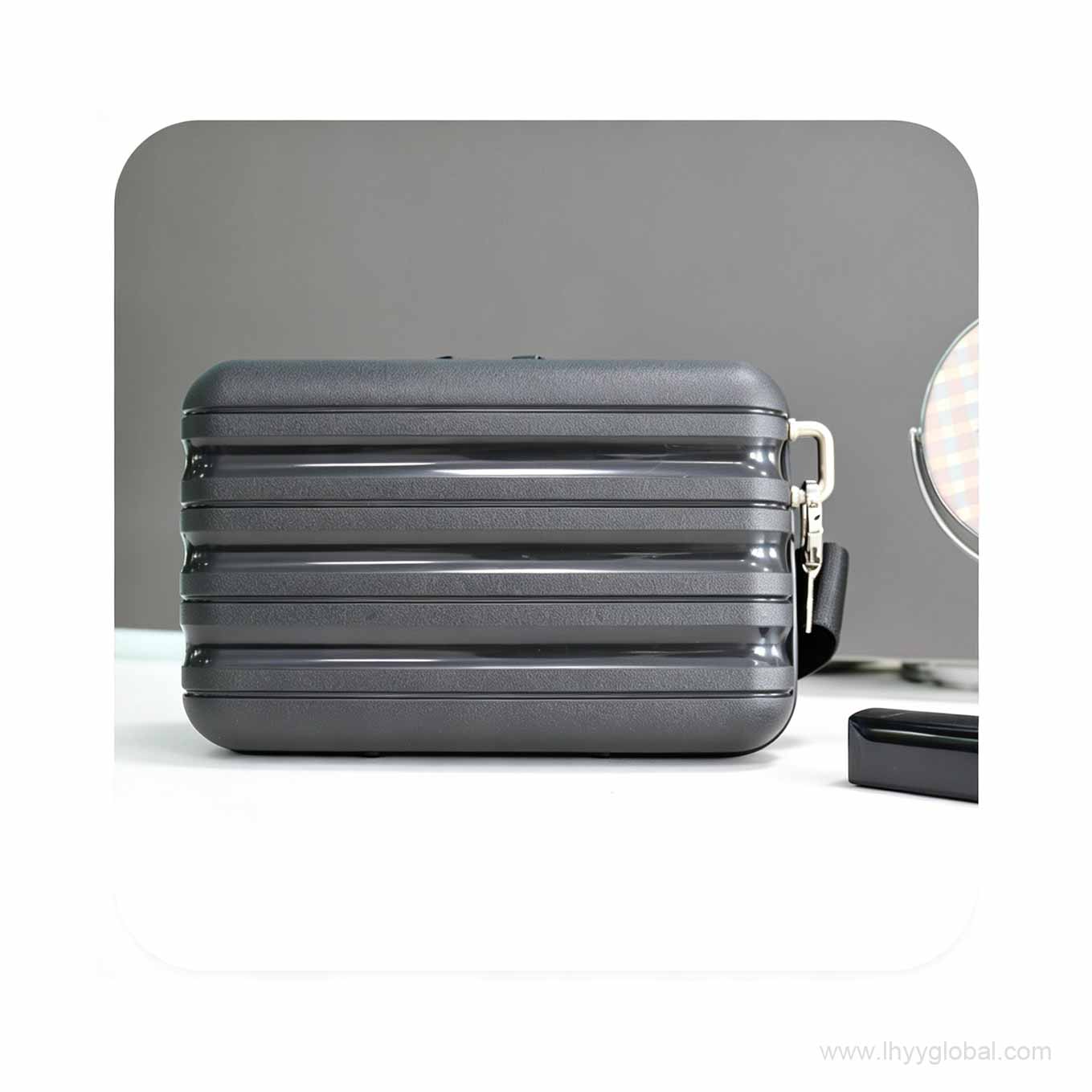 Premium dark grey hard shell mini case with horizontal ribbed design, ideal for biotech corporate swag and tech accessory storage.