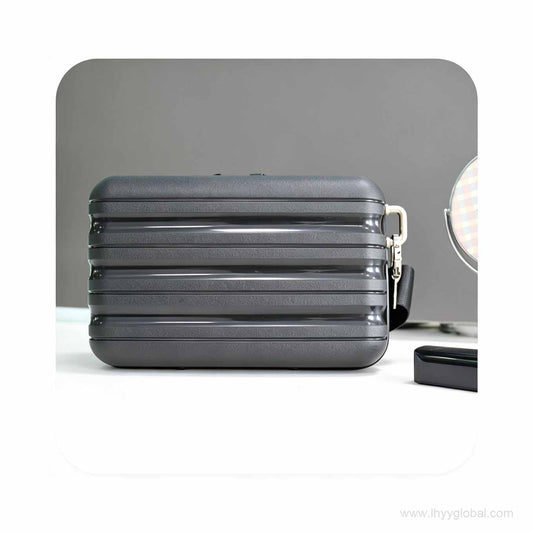 Premium dark grey hard shell mini case with horizontal ribbed design, ideal for biotech corporate swag and tech accessory storage.