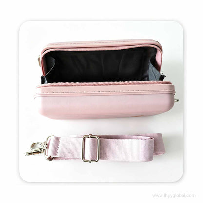 Flat lay view of a customized pink PP mini case showing the spacious black interior and detachable woven strap.