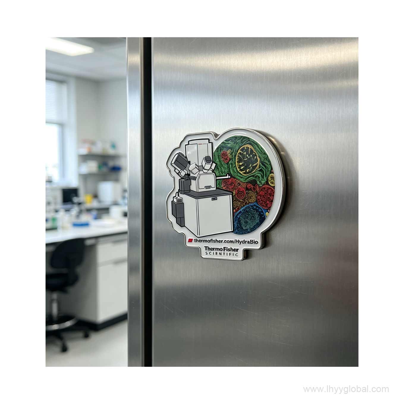 Lifestyle shot of a Thermo Fisher HydraBio electroplated nickel metal magnet attached to a stainless steel lab refrigerator, showcasing its premium metallic finish.