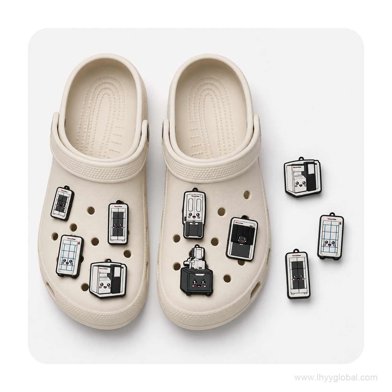 Close-up arrangement of custom Thermo Fisher scientific instrument shoe charms beside a white clog