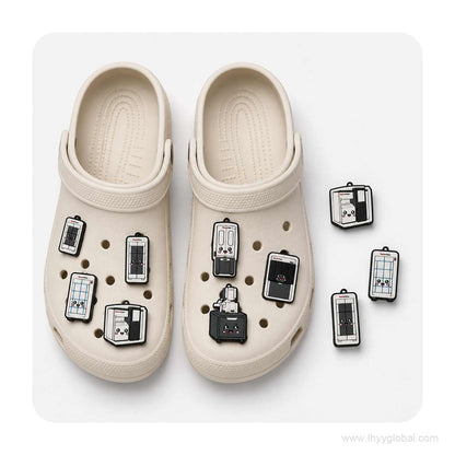 Close-up arrangement of custom Thermo Fisher scientific instrument shoe charms beside a white clog